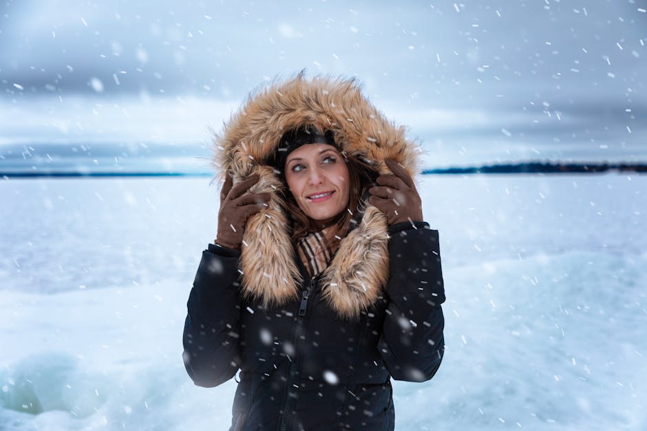 A woman in a fur-trimmed coat enjoying a snowy day outdoors in Ontario, Canada.