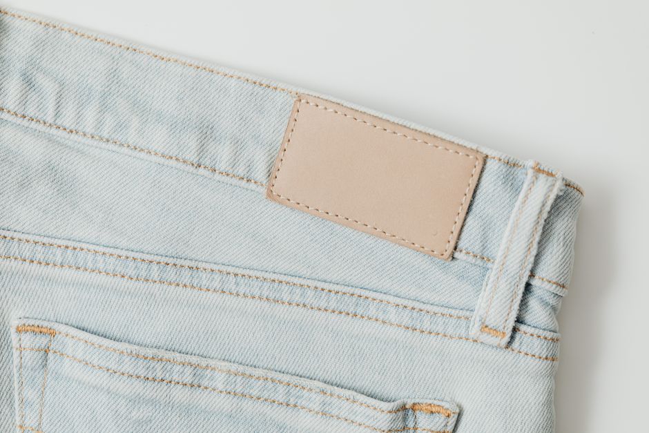 Detailed shot of light blue denim jeans showcasing pocket and stitching.