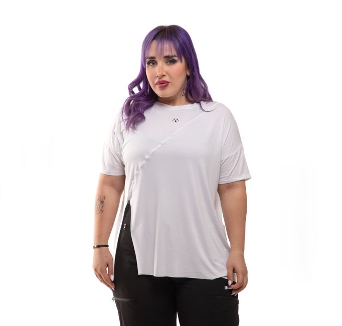 Model showcasing trendy sportswear with a white top and black leggings in a studio setting.