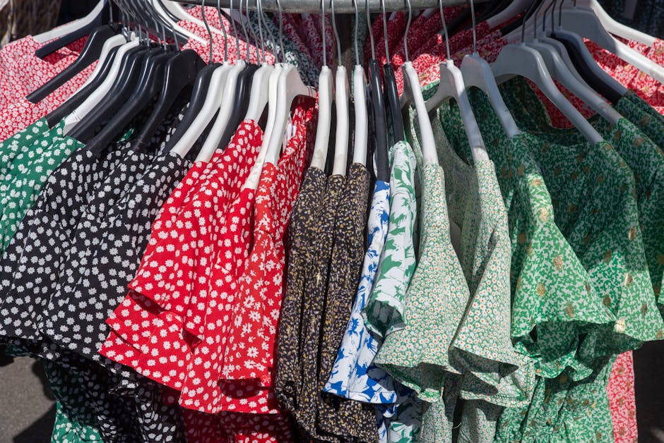 Vibrant collection of floral and patterned dresses hanging on a clothing rack, showcasing diverse styles.