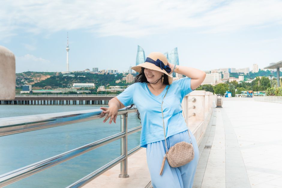 Woman enjoying a sunny day by the Caspian Sea in Baku, Azerbaijan.